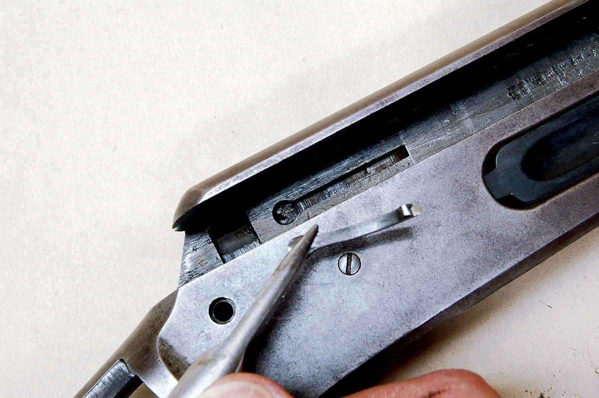 The ejector is unattached behind breechblock. Lift it out after the breechblock is removed.